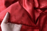 ткань подклад из вискозы красного цвета с логотипами